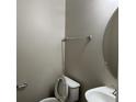 Simple half-bath with a pedestal sink and oval mirror at 113 Ellis Dr, Conyers, GA 30012