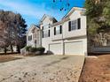 A beautiful two-story home with a three-car garage and a large driveway at 125 Cedars Glen Cir, Villa Rica, GA 30180