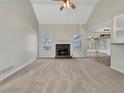 Spacious living room with a fireplace, vaulted ceiling, and large windows at 125 Cedars Glen Cir, Villa Rica, GA 30180
