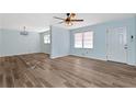 Spacious living room with light blue walls and wood-look flooring at 4251 Hamilton Mill Rd, Buford, GA 30519