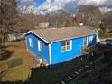 Back view of a blue house with a fenced backyard and an AC unit at 149 Bixby Se Ter, Atlanta, GA 30317