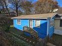 Blue home with a fenced yard, wooden stairs, and a satellite dish at 149 Bixby Se Ter, Atlanta, GA 30317