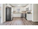 Bright kitchen with white cabinets, granite countertops, and stainless steel appliances at 1786 Ledo Ave, Decatur, GA 30035