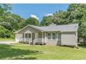 Single-story home with a front-facing garage, covered porch, and grassy front lawn at 6226 Pine Ln, Douglasville, GA 30135