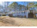 Gray brick ranch house with a landscaped yard at 8661 Chestnut Ln, Lithia Springs, GA 30122