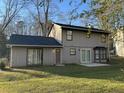 The backyard features sliding glass doors and a small concrete patio at 1654 Tree Line Rd, Lithonia, GA 30058