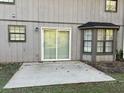 The back of the home showcases a sliding door, windows, and a patio area at 1654 Tree Line Rd, Lithonia, GA 30058