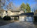 Two-story home with a two-car garage and a concrete driveway at 1654 Tree Line Rd, Lithonia, GA 30058