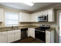 Modern kitchen with stainless steel appliances and granite countertops at 4731 Kings Hwy, Douglasville, GA 30135
