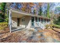 Tan brick ranch home with a covered carport and steps leading to the front door at 2329 Meadowlane Sw Dr, Atlanta, GA 30311