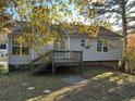 House exterior showcasing a wooden deck and a grassy backyard at 6268 Marbut Farms Trl, Lithonia, GA 30058