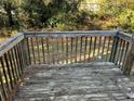 Wooden deck overlooking a grassy backyard, ideal for outdoor relaxation at 6268 Marbut Farms Trl, Lithonia, GA 30058
