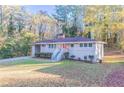 Ranch house with a red door and large yard at 2836 Hedgewood Nw Dr, Atlanta, GA 30311