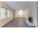Spacious living room featuring hardwood floors and a brick fireplace at 2836 Hedgewood Nw Dr, Atlanta, GA 30311
