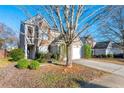 Two-story house with a tree in front and a two-car garage at 3282 Victoria Sw Park, Atlanta, GA 30331