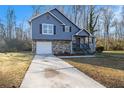 Newly renovated blue house with stone accents and a large yard at 100 Spicewood Ct, South Fulton, GA 30349