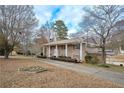 Brick Ranch home with a long driveway and mature trees at 2192 Weslan Dr, Austell, GA 30106