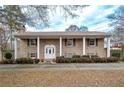 Ranch house with covered entry, landscaping, and a long driveway at 2192 Weslan Dr, Austell, GA 30106
