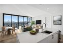 Modern kitchen with white cabinetry, quartz countertops, and island with seating at 2425 Peachtree Ne Rd # 1106, Atlanta, GA 30305