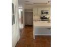 Island kitchen with white cabinets and terracotta tile floors at 3262 Carriage Way, Marietta, GA 30062