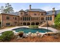 Inviting freeform pool with brick patio and lush landscaping at 6206 Zell Miller Nw Path, Acworth, GA 30101