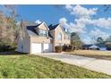 Two-story brick home with a two-car garage and a large yard at 116 Rolling Meadows Ct, Hampton, GA 30228