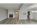 Spacious living room with hardwood floors, a stone fireplace, and access to other rooms at 2683 Meadowlawn Se Dr, Marietta, GA 30067