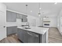 Modern kitchen with gray cabinets, white countertops, and an island at 3328 Pepperpike Ct, Loganville, GA 30052
