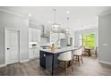 Modern kitchen with a large island, white cabinets, and a breakfast area at 1101 Cooks Farm Way, Woodstock, GA 30189