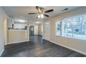 Open living room with dark gray vinyl flooring and kitchen view at 329 Mount Zion Sw Rd, Atlanta, GA 30354