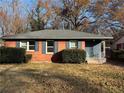 Brick ranch home with dark shutters, landscaping, and a spacious yard at 721 Yale Sw Pl, Atlanta, GA 30315