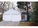 Three-car garage, white exterior, landscaping at 2688 Crystal Ln, Lawrenceville, GA 30044