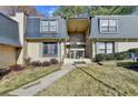 Condo building exterior with landscaping and walkway at 123 Maison Nw, Atlanta, GA 30327