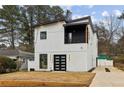 Modern two-story house with white siding, black accents, and a attached garage at 2208 Baker Nw Rd, Atlanta, GA 30318