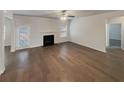 Spacious living room featuring hardwood floors and a fireplace at 607 Stream Ct, Fairburn, GA 30213