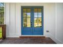 Blue double front doors with glass panes leading to a wooden deck at 2587 Kingsley Ne Dr, Marietta, GA 30062