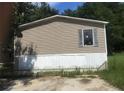 Tan mobile home with white skirting at 815 Dogwood Trl, Jonesboro, GA 30238