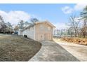Two-car garage with a long driveway at 3686 Thurman Rd, Atlanta, GA 30349