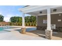 Community pool with covered seating area and safety warnings at 1080 Cades Walk, Lawrenceville, GA 30045