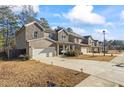 Houses with attached garages and manicured lawns at 75 Glen Abbey Cir, Fairburn, GA 30213