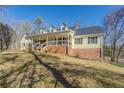 Yellow house with a large front yard and porch at 1060 River Cove Rd, Social Circle, GA 30025