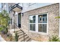 Townhome features a modern front entrance with brick accents and metal railing at 1923 Rogers Ct, Atlanta, GA 30318