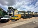 Row of new construction townhouses under a partly cloudy sky at 1095 Tucker Ave # 405, Atlanta, GA 30310
