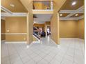 Bright entryway with high ceilings, tile floors, and a staircase at 250 Windsor Way, Fairburn, GA 30213