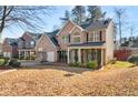 Two-story house with a covered porch and landscaping at 250 Windsor Way, Fairburn, GA 30213