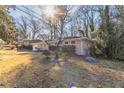 Side view of ranch home showcasing landscaping and wooded surroundings at 2330 Dorsey Ave, Atlanta, GA 30344