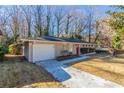 Front view of a ranch home with a white garage door and driveway at 2330 Dorsey Ave, Atlanta, GA 30344