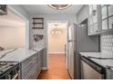 Modern kitchen with gray cabinets and quartz countertops at 2619 Vinings Central Se Dr, Atlanta, GA 30339