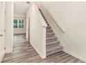 Modern staircase with gray carpeting and wood-look flooring at 1502 Vernon Blvd, Decatur, GA 30035