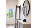 Bright entryway with coat rack, large mirror, and console table at 7573 Knoll Hollow Rd, Lithonia, GA 30058